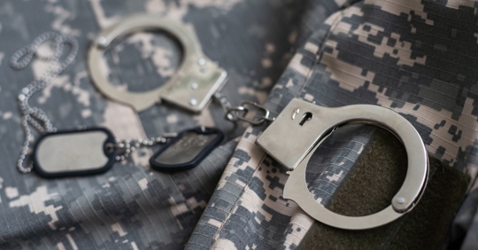 handcuffs on top of a military uniform